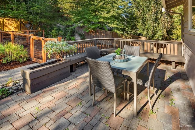 a balcony with wooden floor table and chairs
