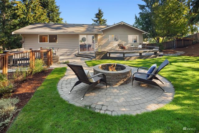 a view of a house with backyard sitting area and swimming pool