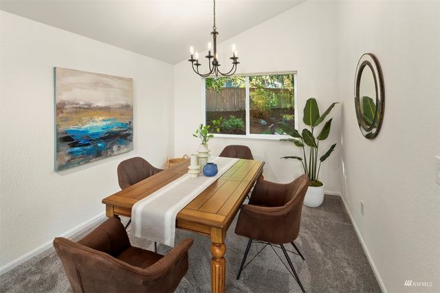 a dining room with furniture and a chandelier