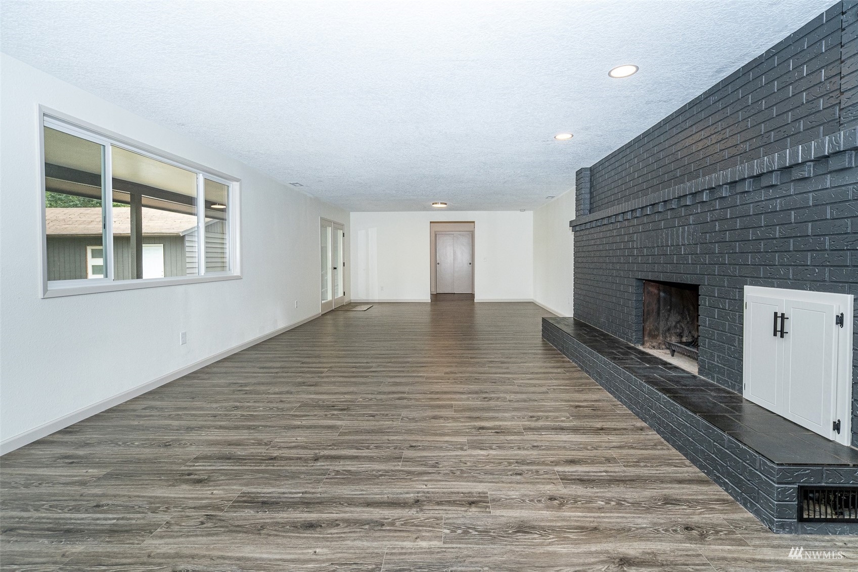 1861 Bishop Road Chehalis, WA 98532 - Photo 4 of 38 a view of empty room with wooden floor and fireplace