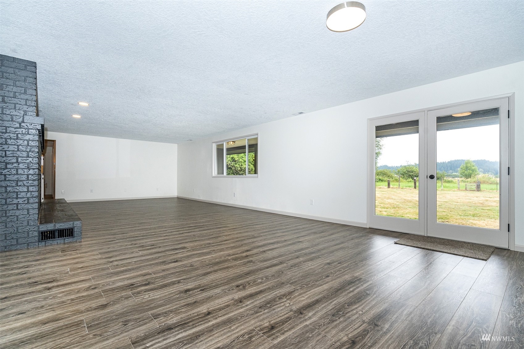 1861 Bishop Road Chehalis, WA 98532 - Photo 5 of 38 a view of an empty room with a window and wooden floor