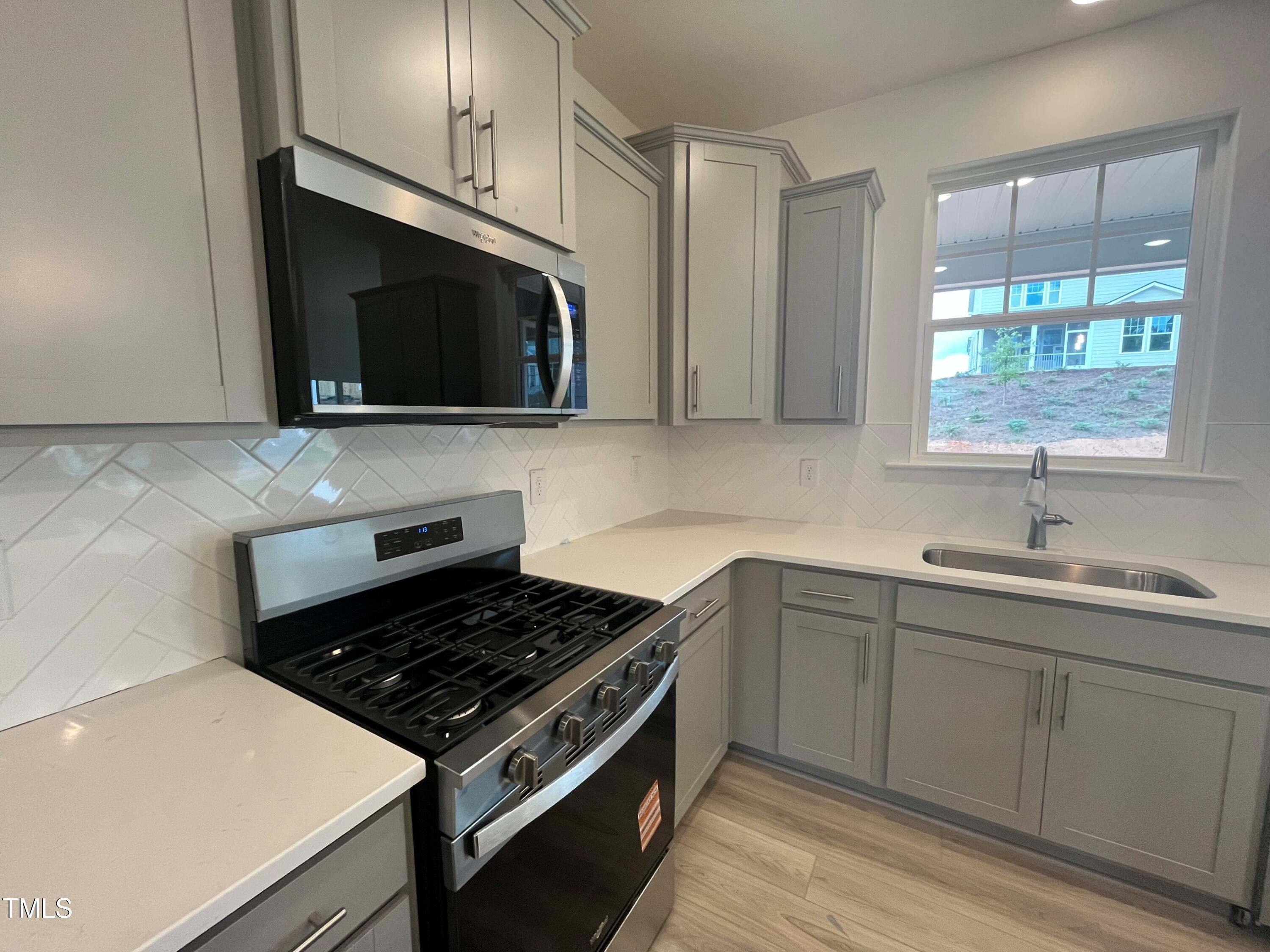 779 Old Station Pointe Angier, NC 27501 - Photo 6 of 33 a kitchen with stainless steel appliances a sink stove and microwave