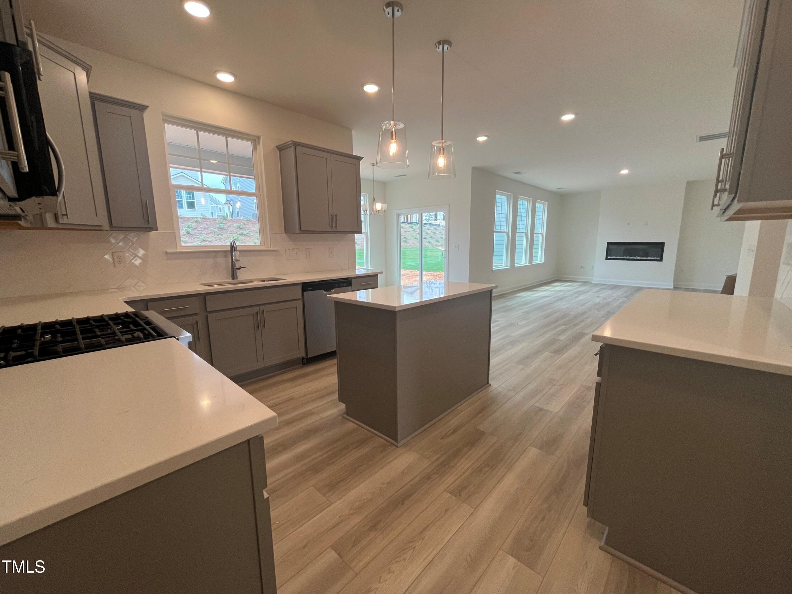 779 Old Station Pointe Angier, NC 27501 - Photo 7 of 33 a large kitchen with stainless steel appliances a large center island attached withe living room