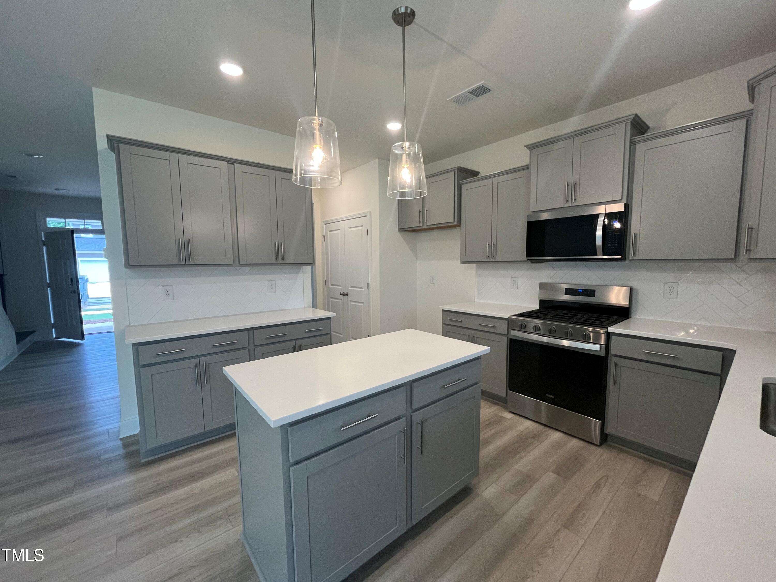 779 Old Station Pointe Angier, NC 27501 - Photo 8 of 33 a kitchen with a sink stove and microwave