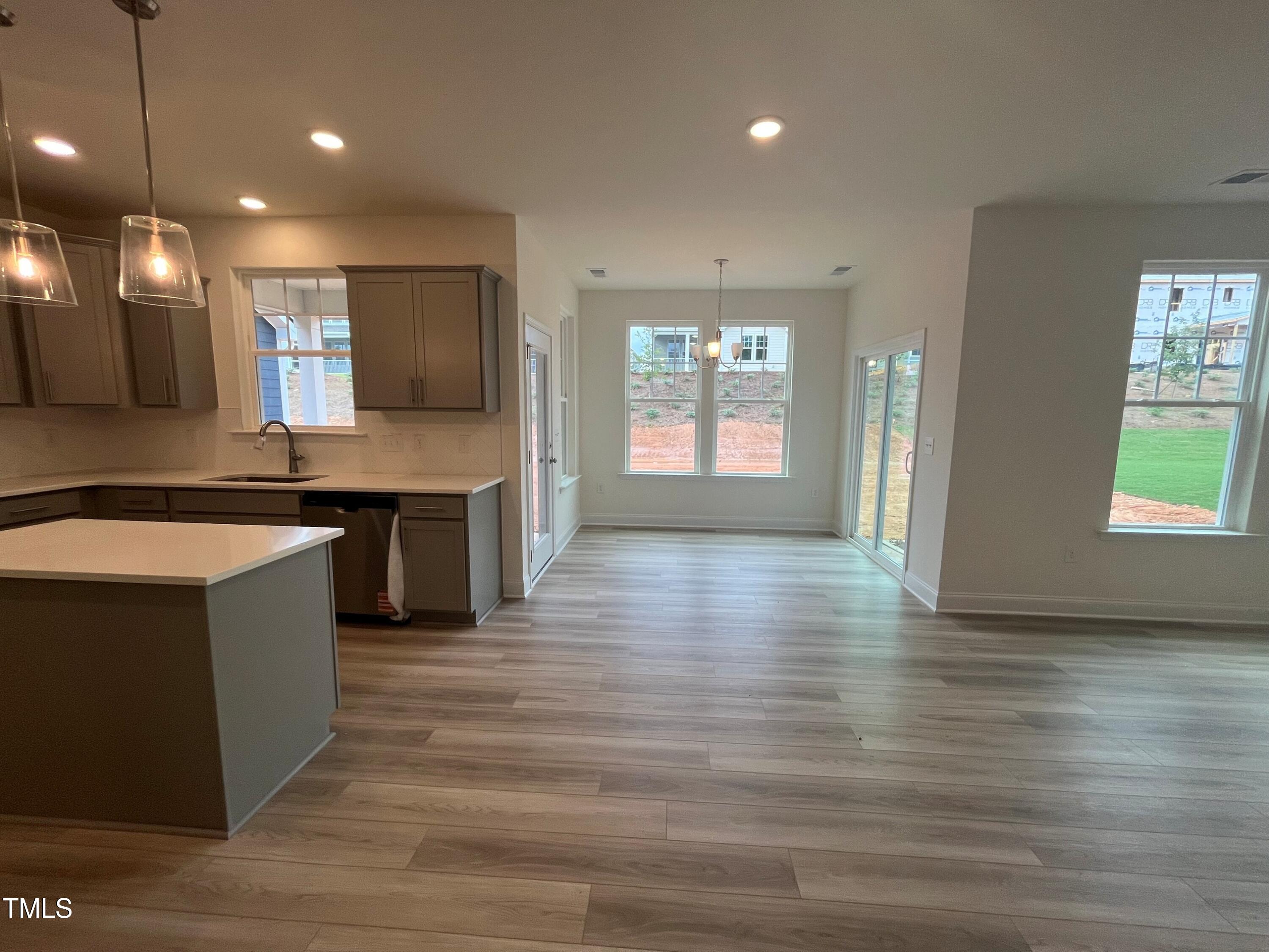 779 Old Station Pointe Angier, NC 27501 - Photo 10 of 33 a kitchen with stainless steel appliances granite countertop a sink a stove and a wooden floors