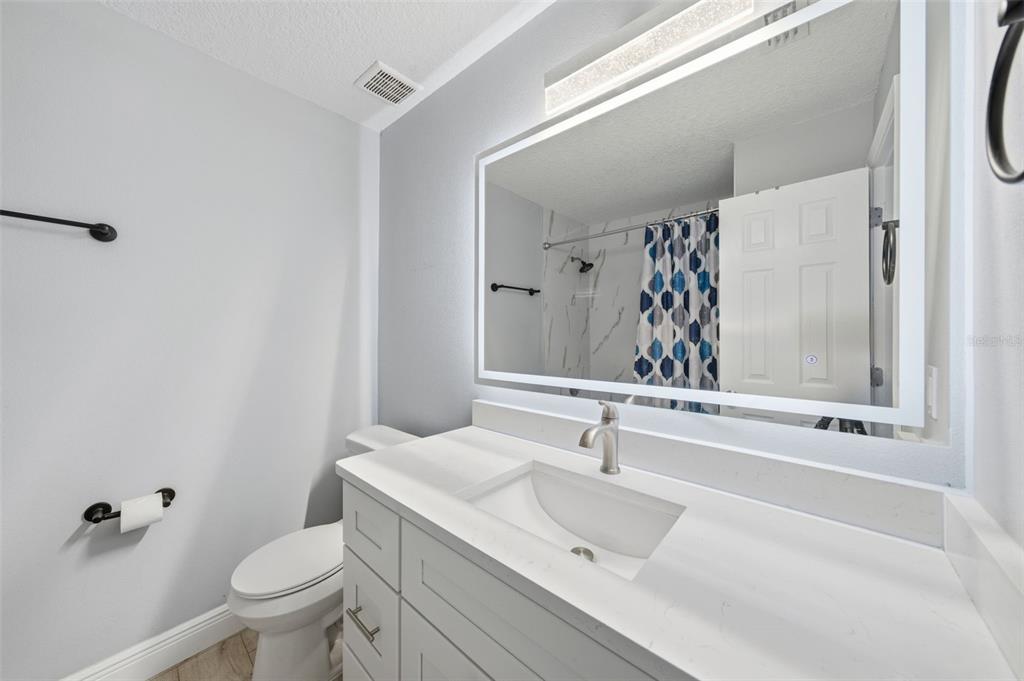 1113 Oakhill Street Seffner, FL 33584 - Photo 11 of 44 a bathroom with a sink toilet and shower