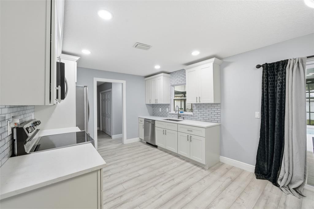 1113 Oakhill Street Seffner, FL 33584 - Photo 36 of 44 a large kitchen with a lot of counter space and wooden floor