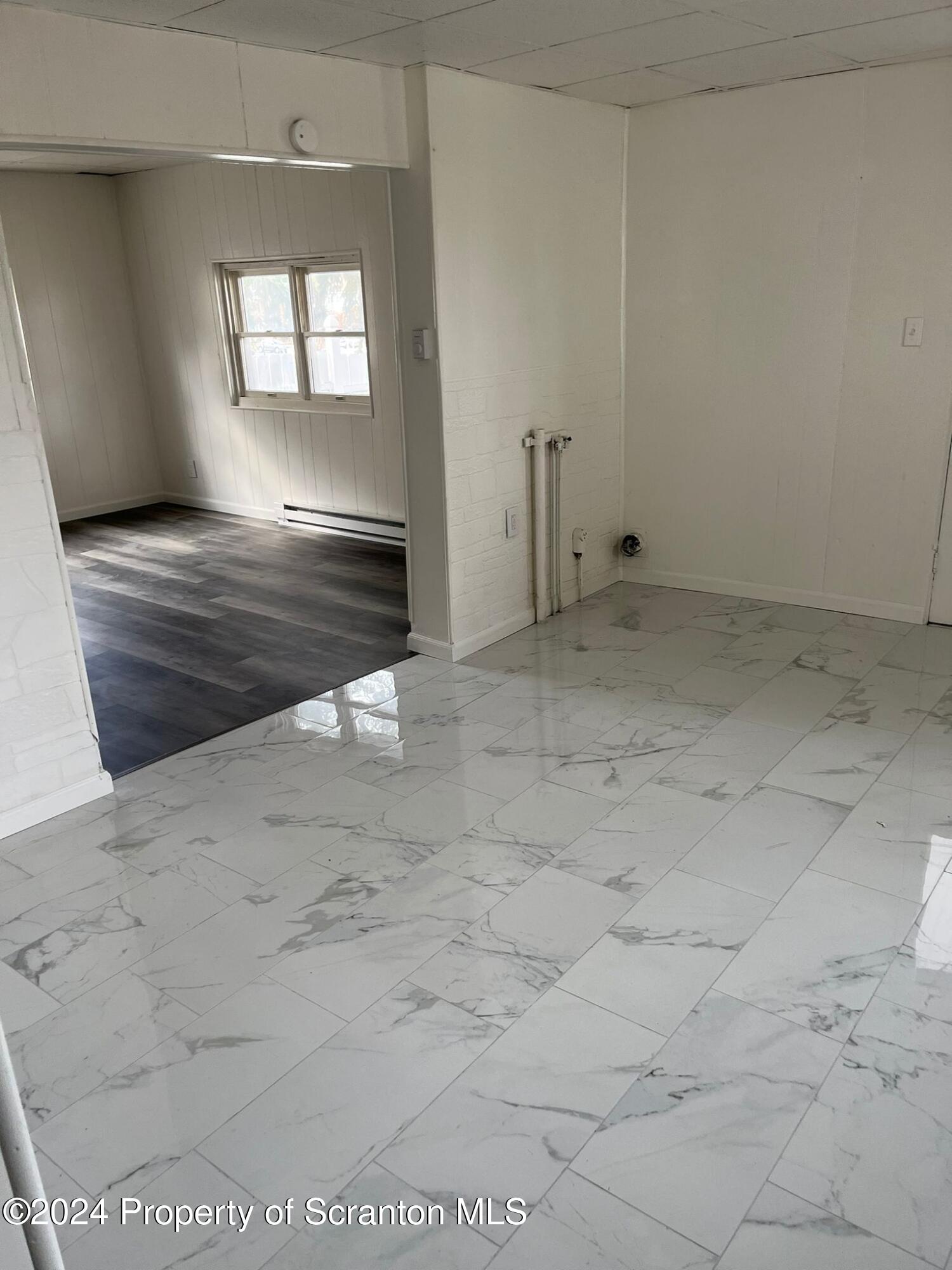 258 Main Street, Unit 3(REAR) Dupont, PA 18641 - Photo 3 of 10 a view of an empty room and window