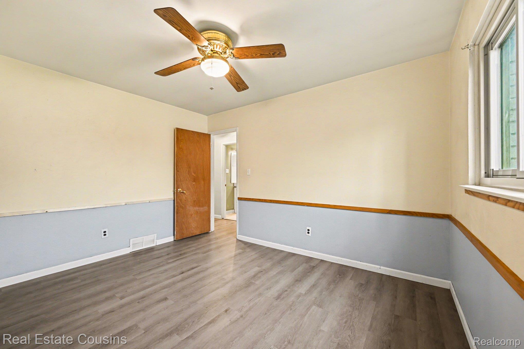 32224 Joy Road Livonia, MI 48150 - Photo 14 of 33 Spare room with dark wood finished floors and a ceiling fan