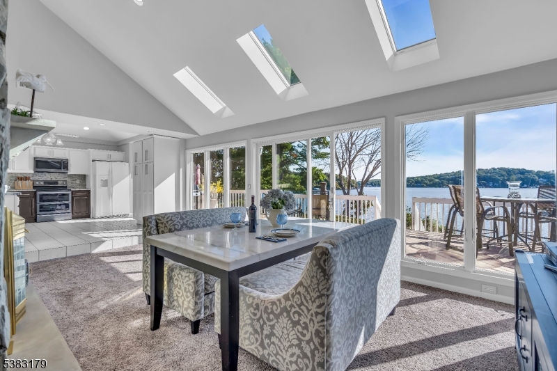 11 Bass Rock Road Hopatcong, NJ 07843 - Photo 14 of 50 a dining room with furniture large windows and a chandelier