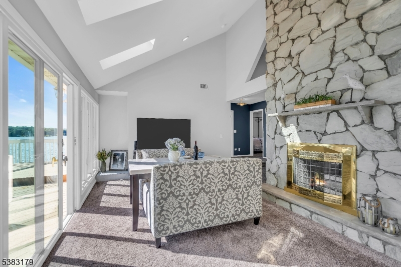 11 Bass Rock Road Hopatcong, NJ 07843 - Photo 16 of 50 a living room with furniture and a fireplace