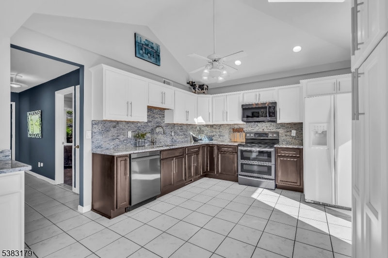11 Bass Rock Road Hopatcong, NJ 07843 - Photo 18 of 50 a kitchen with stainless steel appliances granite countertop a stove sink and refrigerator