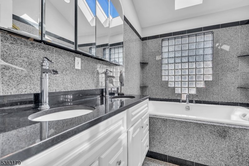 11 Bass Rock Road Hopatcong, NJ 07843 - Photo 25 of 50 a bathroom with a sink and a large mirror