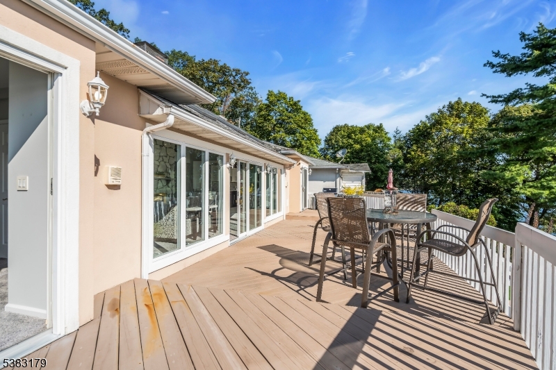 11 Bass Rock Road Hopatcong, NJ 07843 - Photo 30 of 50 a view of a patio with table and chairs with wooden floor and fence