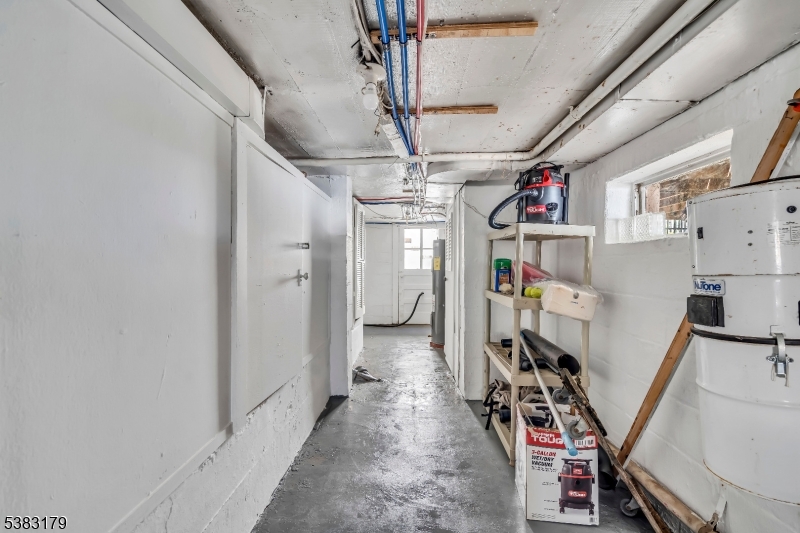 11 Bass Rock Road Hopatcong, NJ 07843 - Photo 50 of 50 a view of hallway with a refrigerator and a chandelier