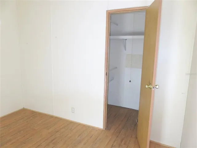 a backyard of a house with lots of green space and glass windows