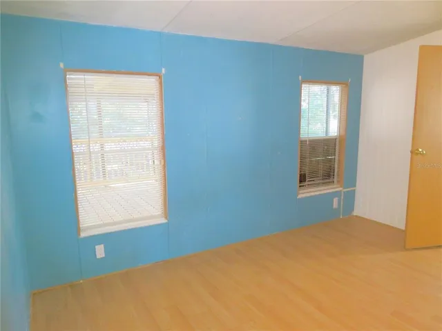 a view of an empty room with closet area