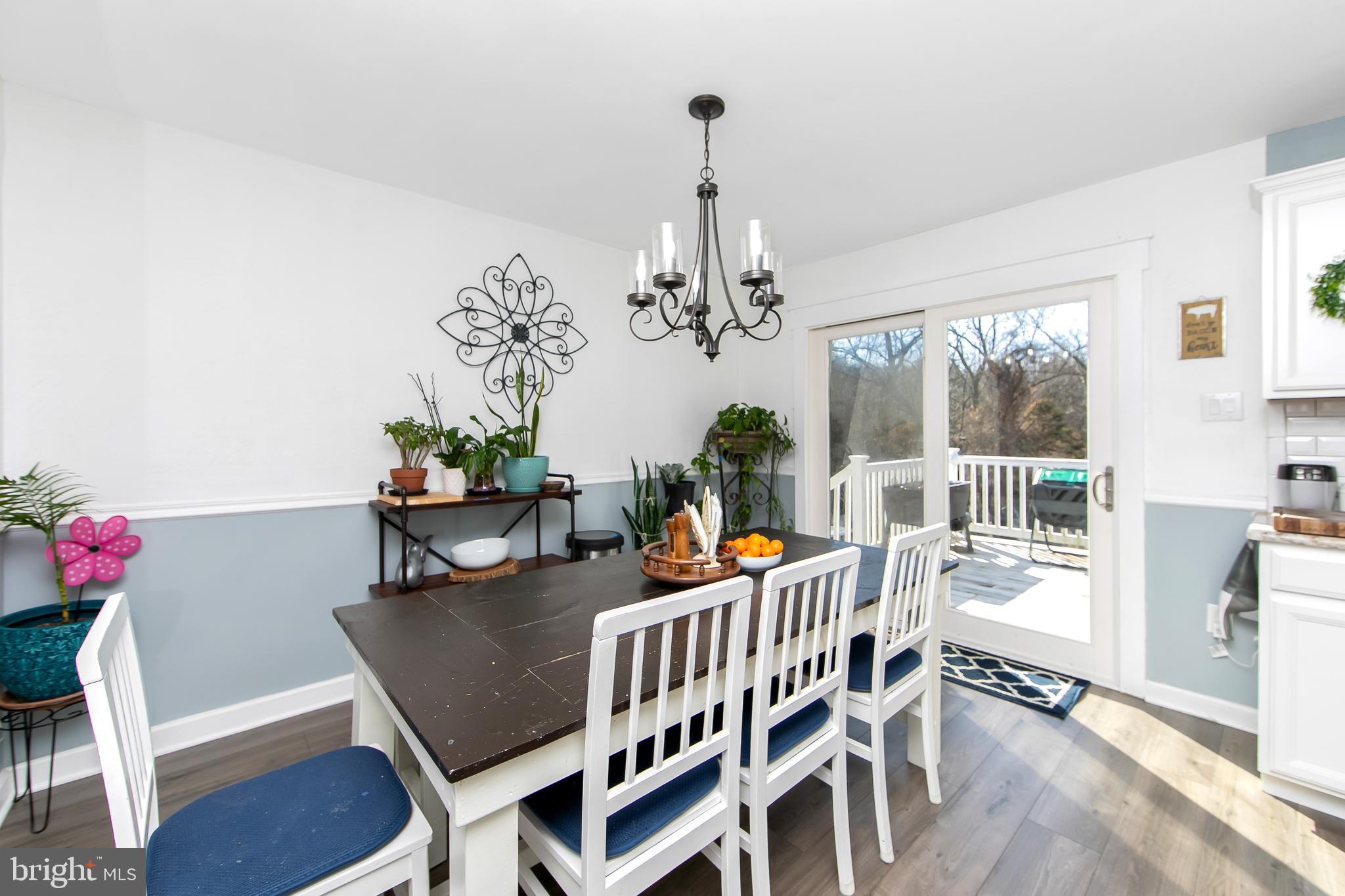 121 Capella Road Sewell, NJ 08080 - Photo 7 of 29 a dining room with furniture a chandelier and wooden floor