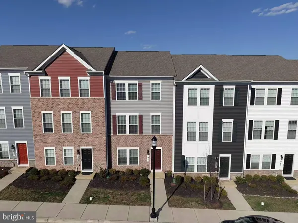 a front view of a residential apartment building with a yard