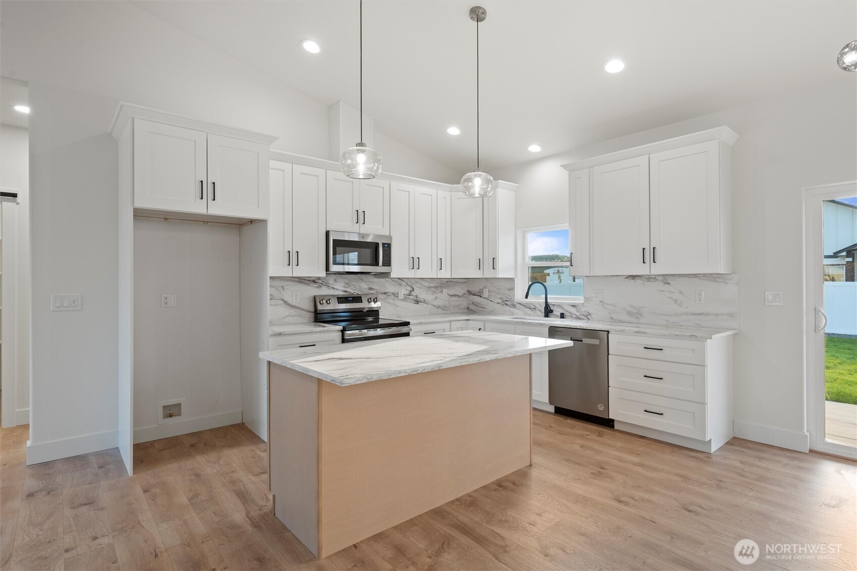 2391 Hunters Street Ephrata, WA 98823 - Photo 11 of 40 a kitchen with white cabinets stainless steel appliances and wooden floor