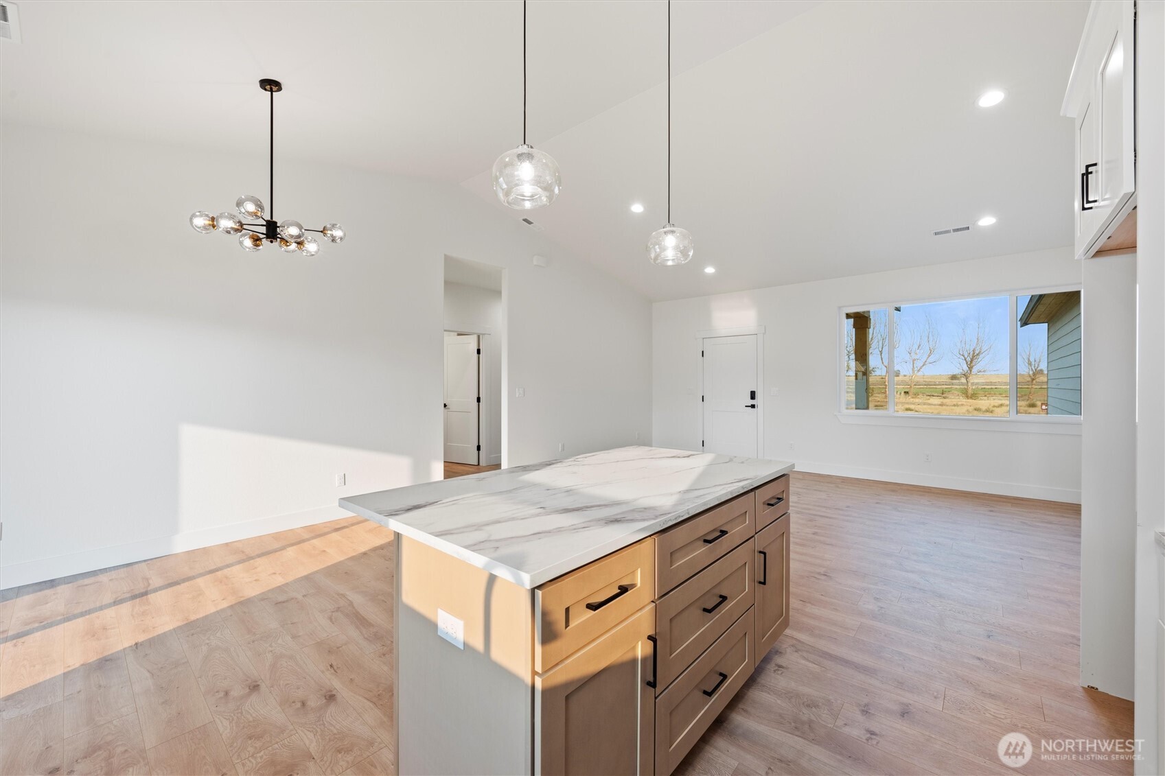 2391 Hunters Street Ephrata, WA 98823 - Photo 13 of 40 a view of a kitchen island with wooden floor and a ceiling fan
