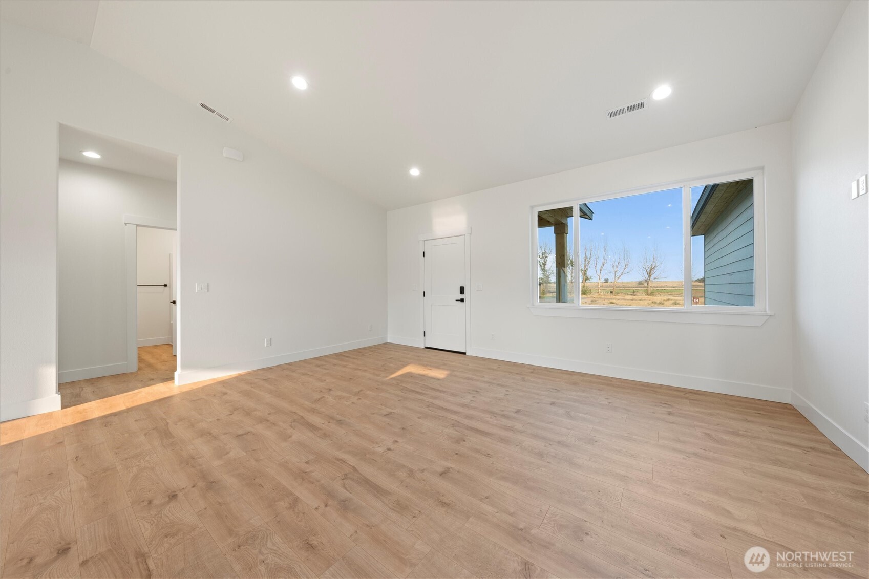 2391 Hunters Street Ephrata, WA 98823 - Photo 17 of 40 a view of an empty room with a window and wooden floor