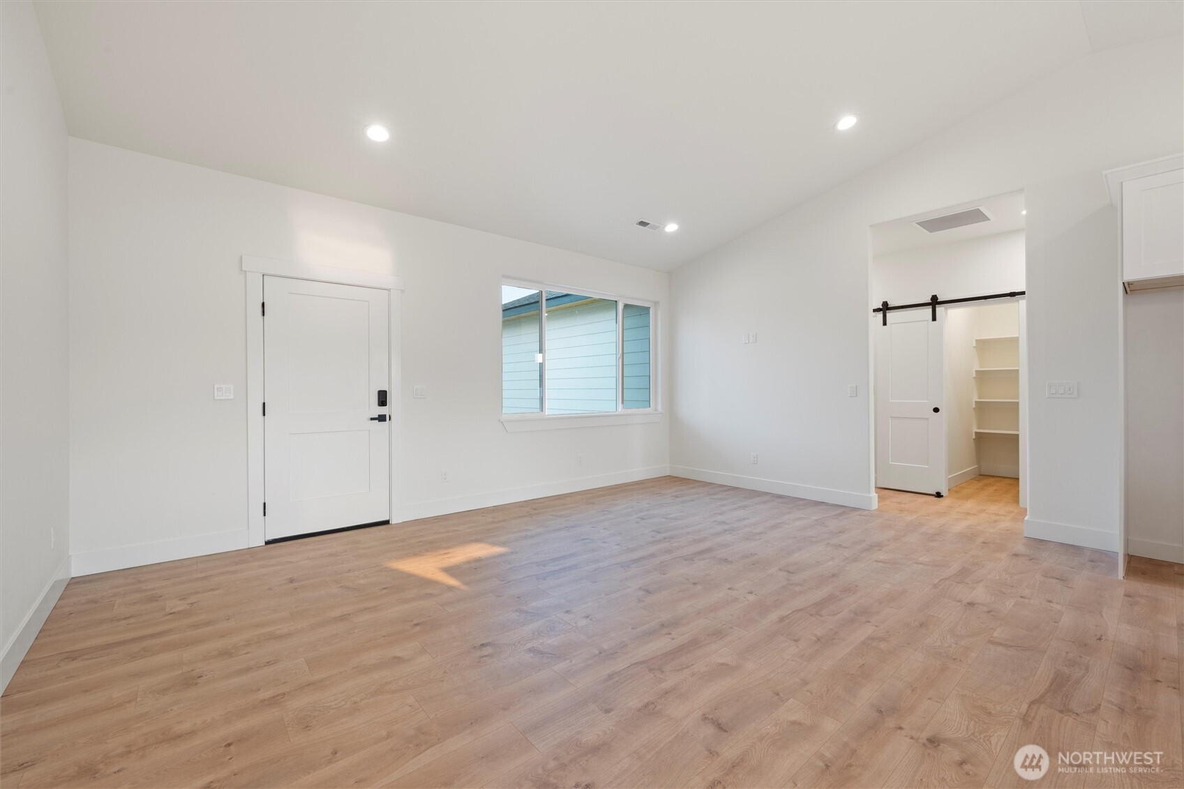 2391 Hunters Street Ephrata, WA 98823 - Photo 18 of 40 a view of an empty room with wooden floor and a window