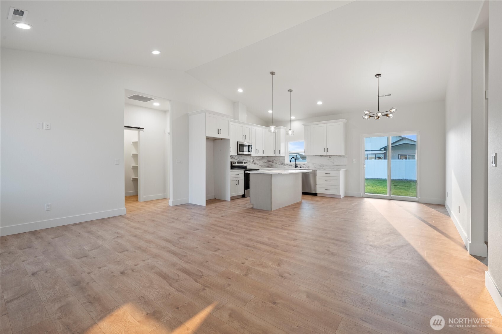 2391 Hunters Street Ephrata, WA 98823 - Photo 19 of 40 a view of a kitchen with a stove wooden cabinets and a fireplace