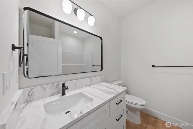 a bathroom with a tub sink and mirror