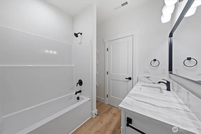 a bathroom with a sink vanity and a mirror