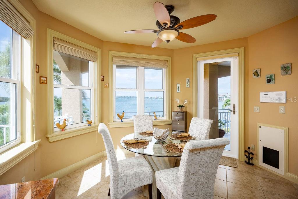 306 Harbor Drive Indian Rocks Beach, FL 33785 - Photo 18 of 49 a dining room with furniture a flat screen tv and a large window