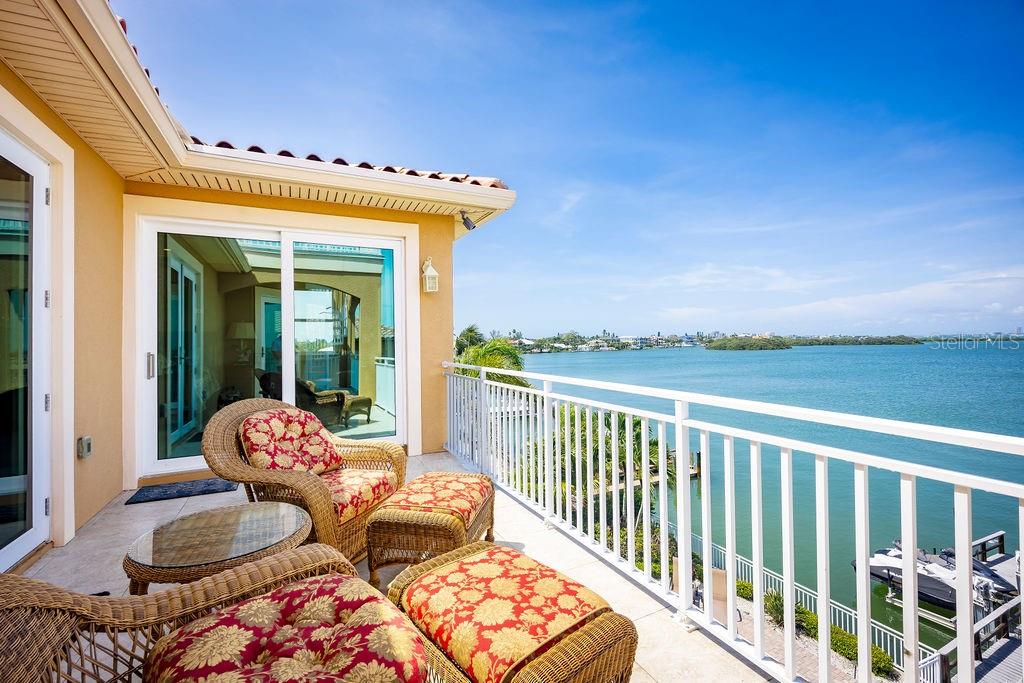306 Harbor Drive Indian Rocks Beach, FL 33785 - Photo 24 of 49 a balcony with an outdoor seating