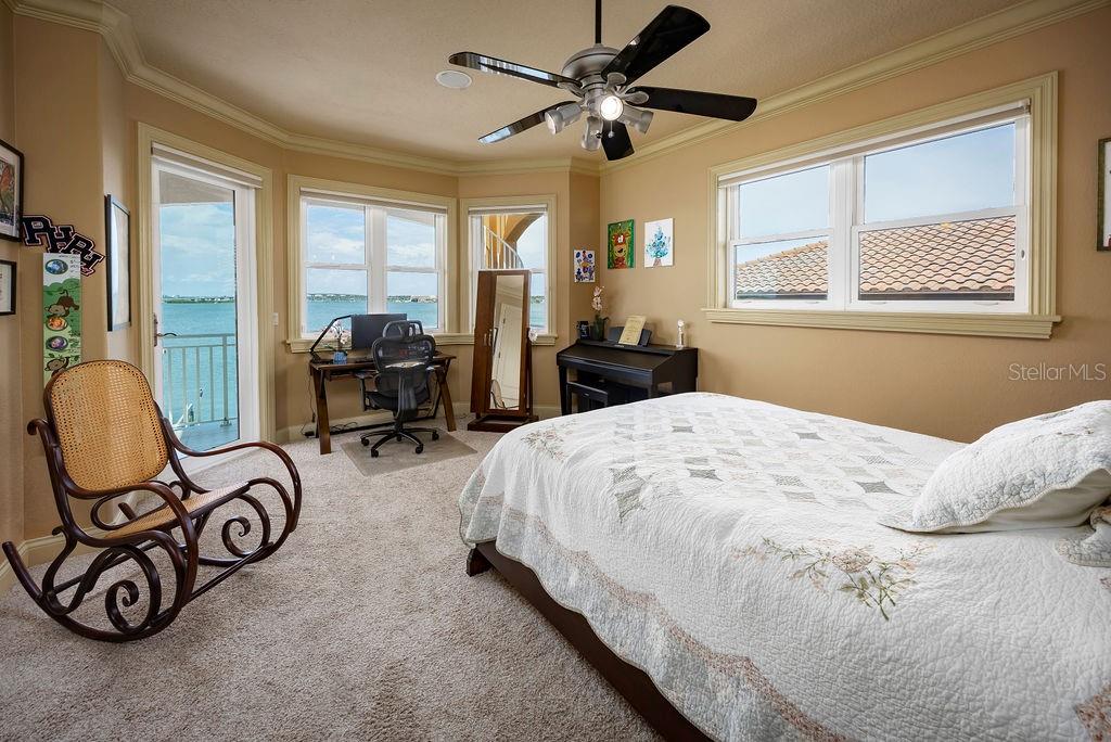 306 Harbor Drive Indian Rocks Beach, FL 33785 - Photo 28 of 49 a bedroom with bed and glass windows