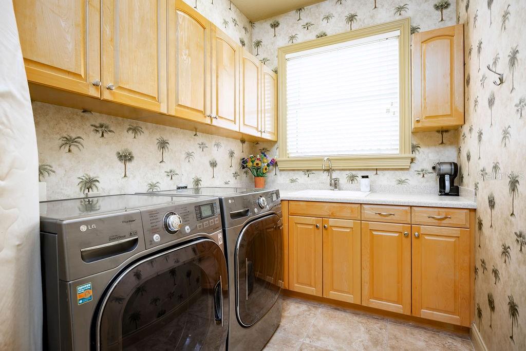 306 Harbor Drive Indian Rocks Beach, FL 33785 - Photo 31 of 49 a utility room with stainless steel appliances washer and dryer