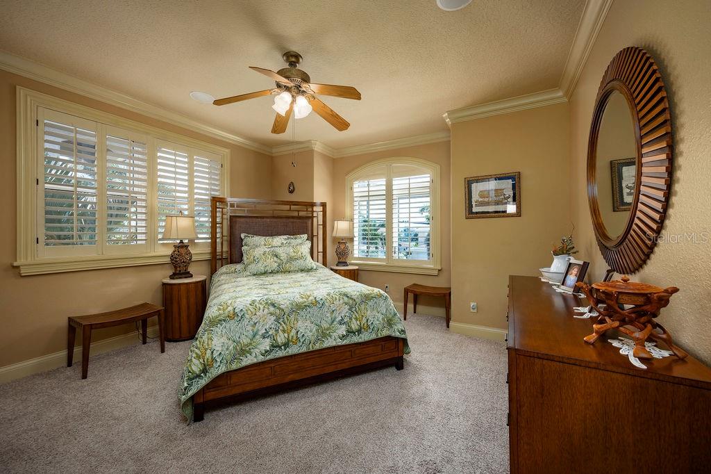 306 Harbor Drive Indian Rocks Beach, FL 33785 - Photo 32 of 49 a bed room with a bed and a chandelier
