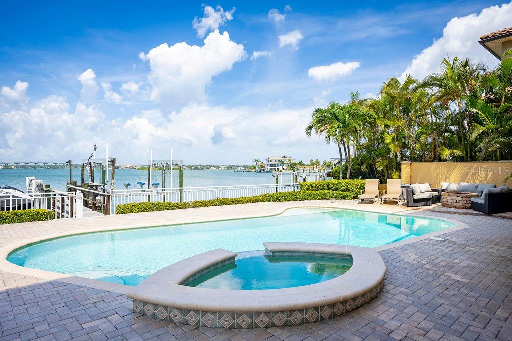 306 Harbor Drive Indian Rocks Beach, FL 33785 - Photo 40 of 49 a view of a swimming pool with an outdoor space and seating area