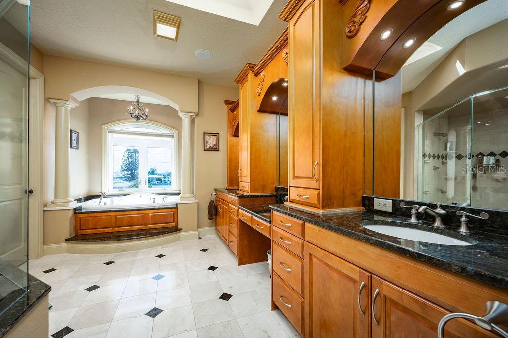 306 Harbor Drive Indian Rocks Beach, FL 33785 - Photo 9 of 49 a large bathroom with a large tub and sink