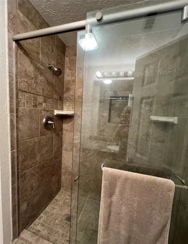 a bathroom with a shower and a sink