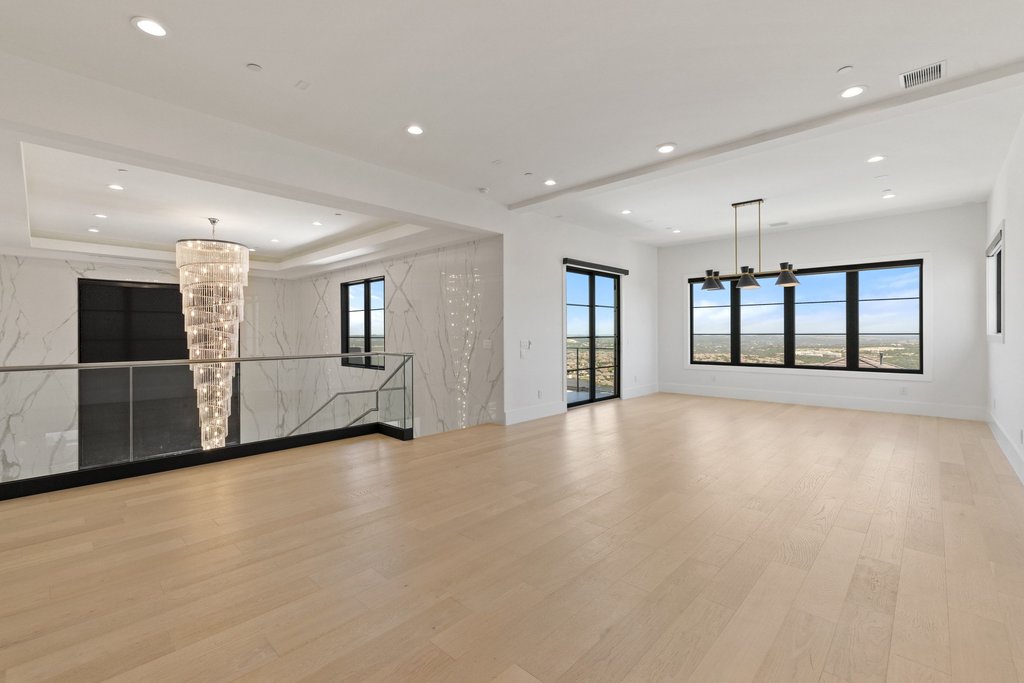 7117 Davenport Divide Road Austin, TX 78738 - Photo 38 of 40 Gleaming hardwood floors and expansive windows create an airy, luminous ambiance in this refined living space.