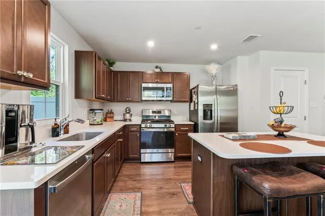 a kitchen with a sink stove and refrigerator