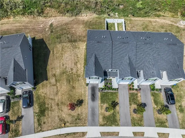 an aerial view of a house with swimming pool and mountains