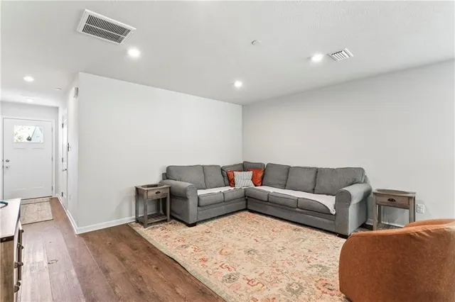 a living room with furniture window and wooden floor