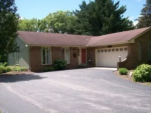 a front view of a house with a yard and a garage