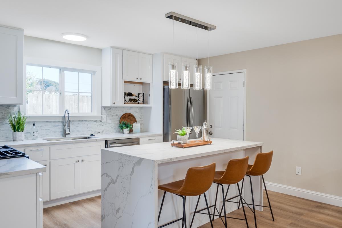 3173 Shuler Circle Marina, CA 93933 - Photo 18 of 55 a kitchen with a table chairs sink and cabinets