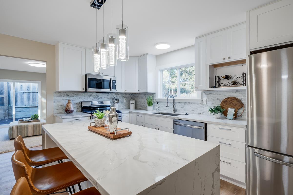 3173 Shuler Circle Marina, CA 93933 - Photo 23 of 55 a kitchen with white cabinets and stainless steel appliances