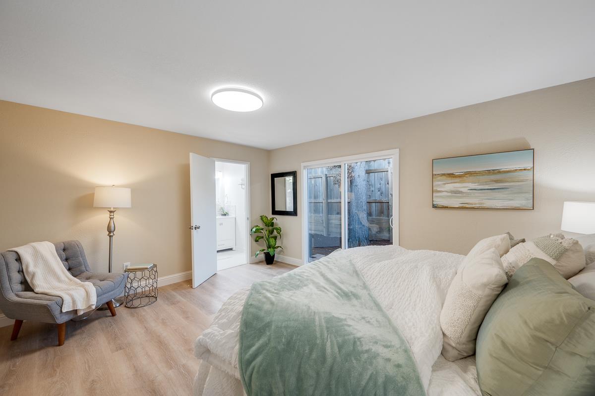 3173 Shuler Circle Marina, CA 93933 - Photo 35 of 55 a spacious bedroom with a bed and wooden floor