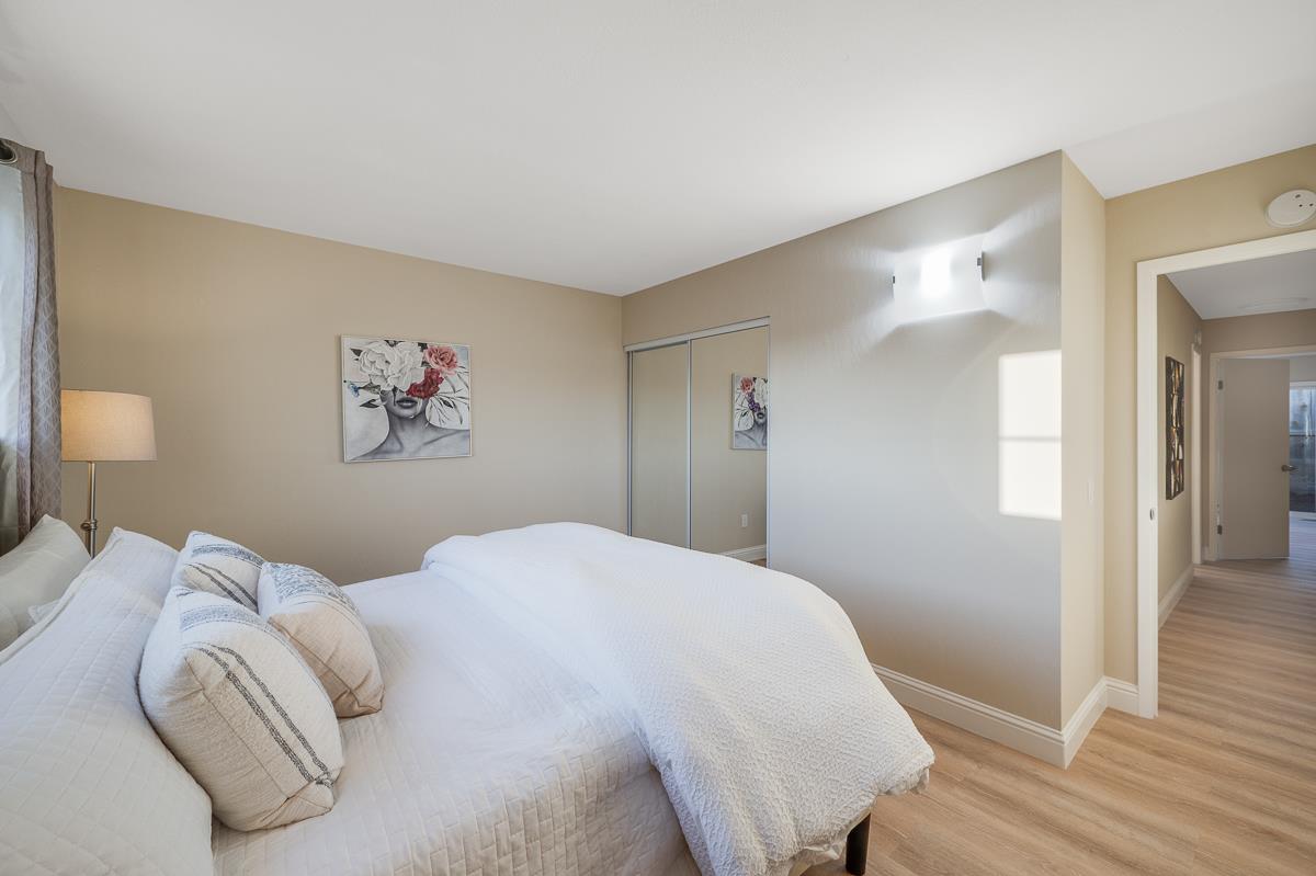 3173 Shuler Circle Marina, CA 93933 - Photo 41 of 55 a bedroom with a large bed and a chandelier