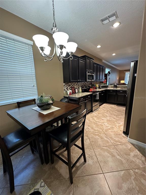 9476 Trumpet Vine Loop Trinity, FL 34655 - Photo 7 of 19 a view of a dining room with furniture