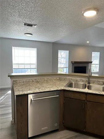 a kitchen with center island and windows