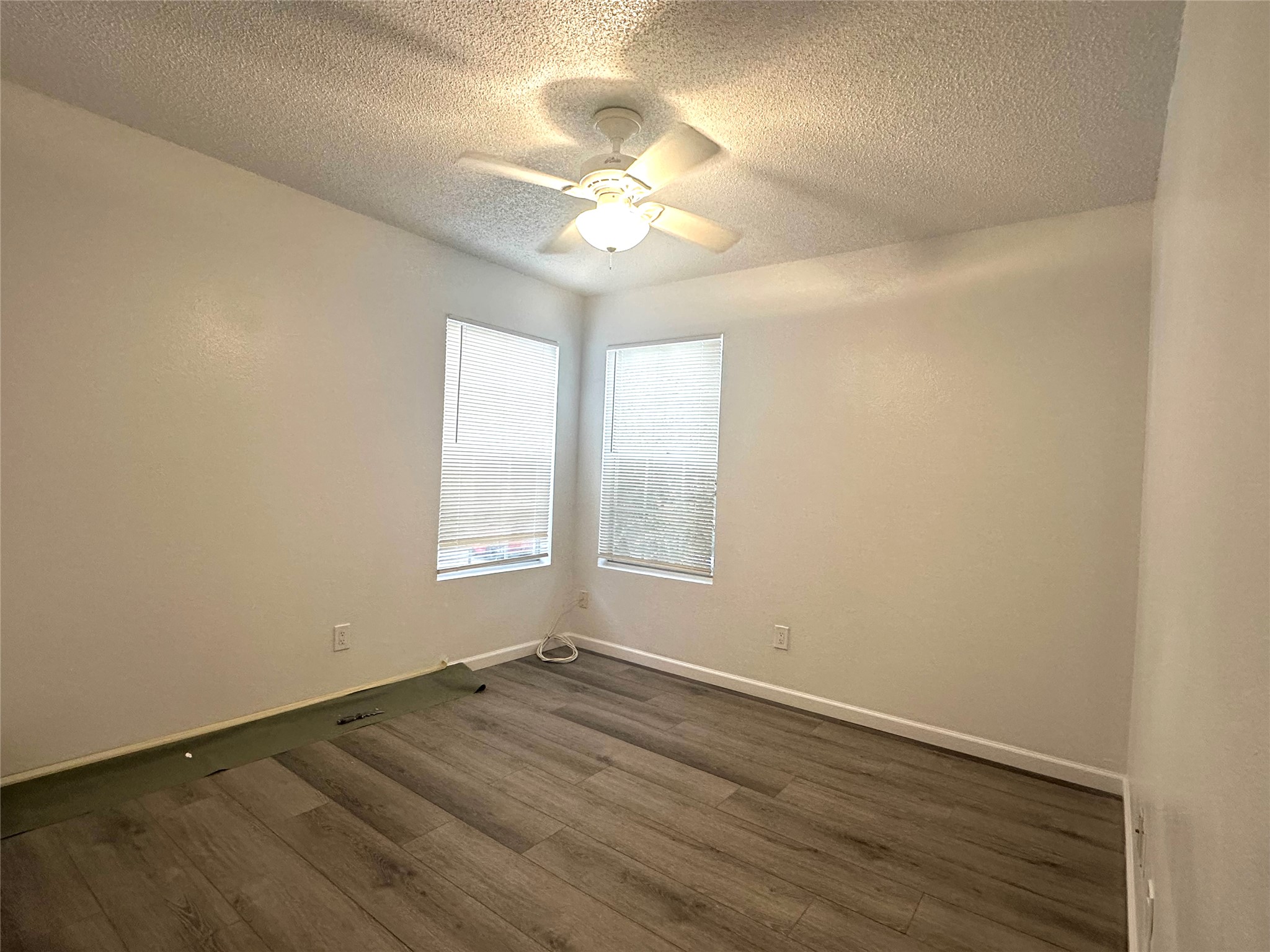 4202 Duval Road, Unit C Austin, TX 78759 - Photo 5 of 8 wooden floor in an empty room with a window